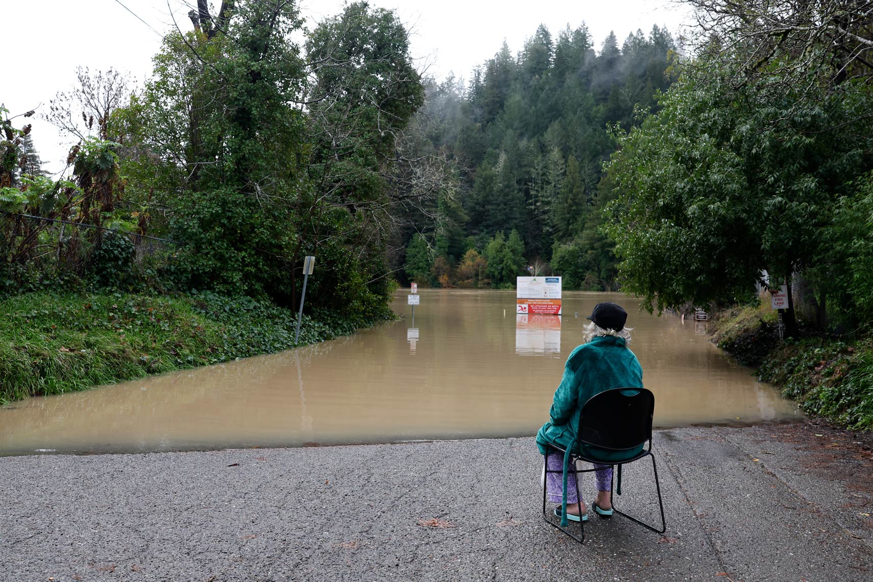 A Woman Watches the Russian River Rise with Floodwater