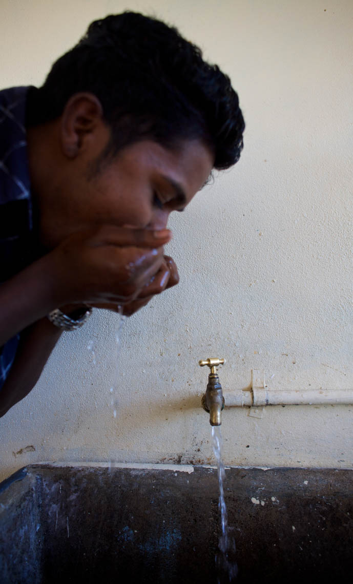 A Man Drinks from a Tap in Fiji