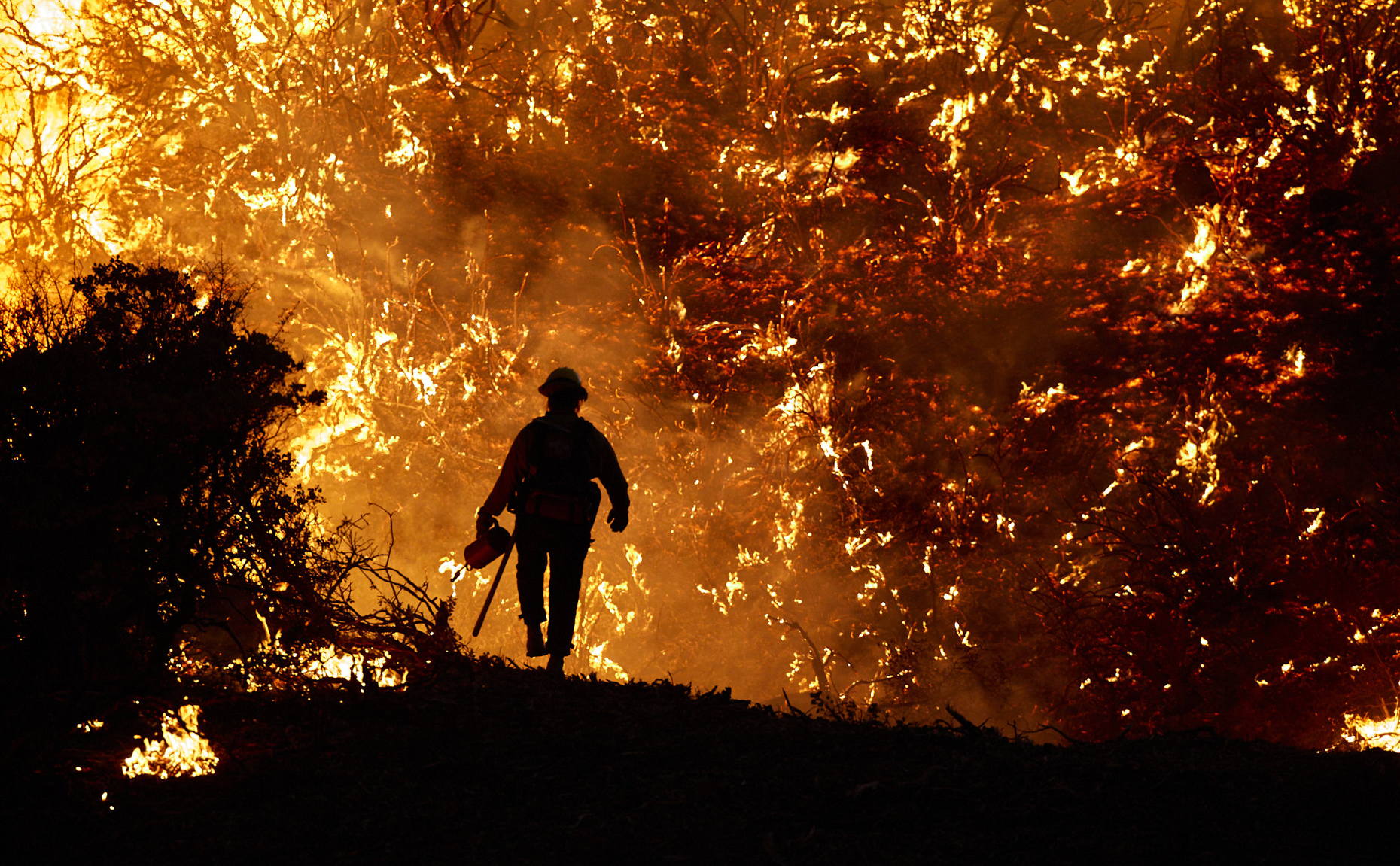 Firefighter Silhouetted by Flames
