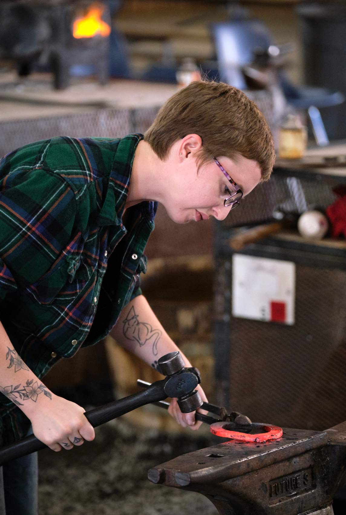 Student Uses Hammer and Anvil to Shape Horseshoe