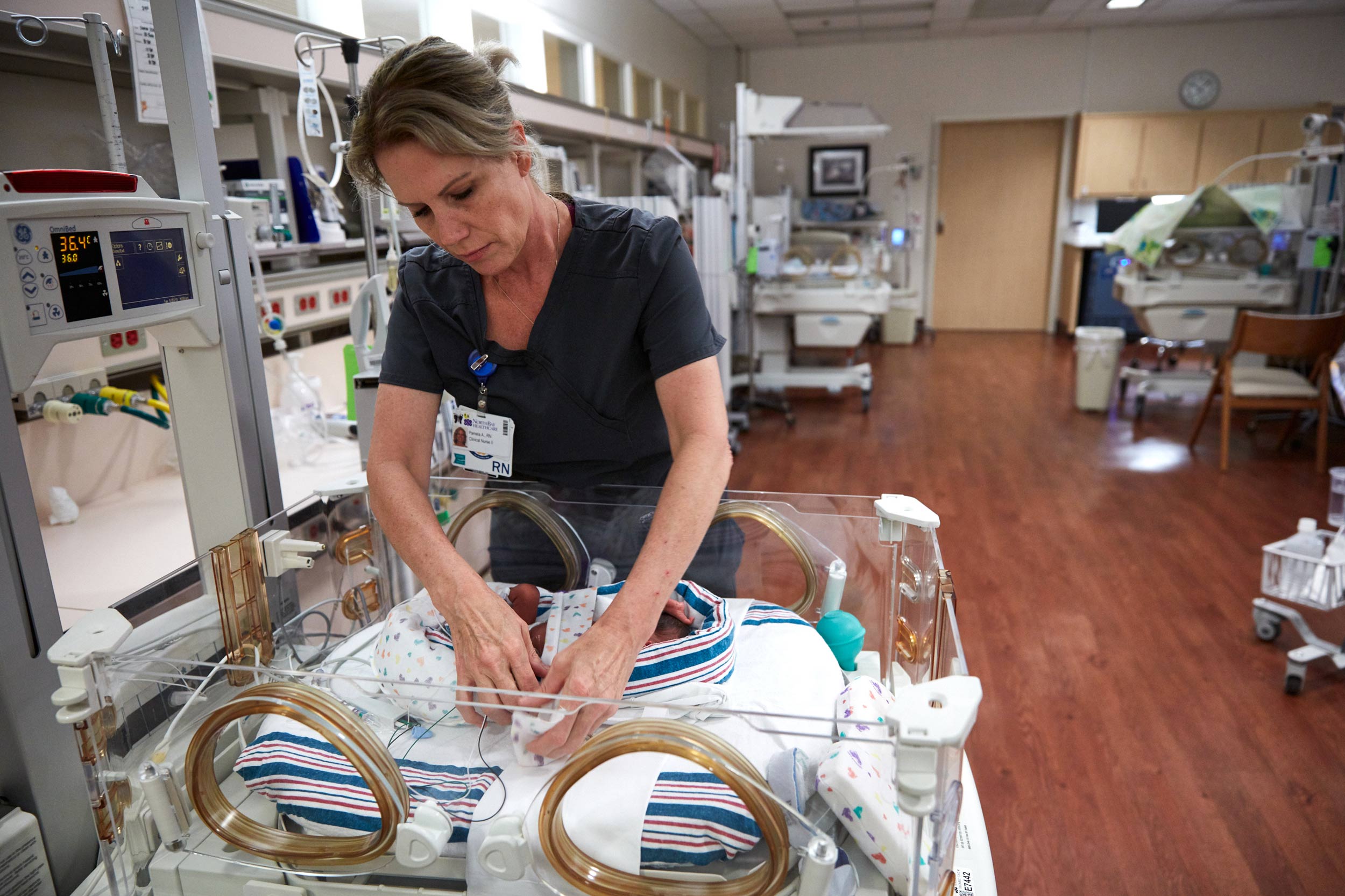 Nurse Cares for Infant in NICU