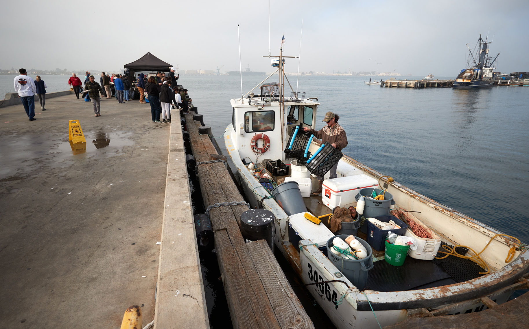 A Fisherman Organizes his Boat After Offloading Catch