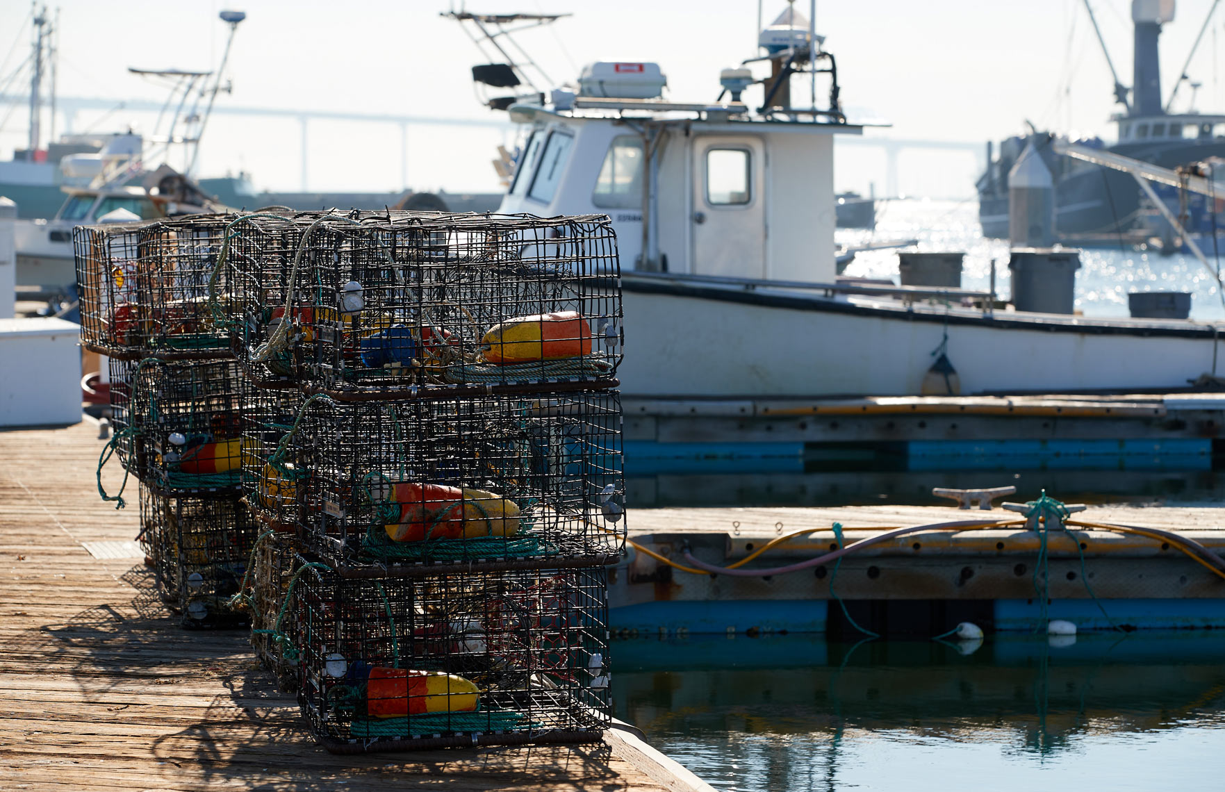Lobster Pots Sit on Dock by Fishing Boat