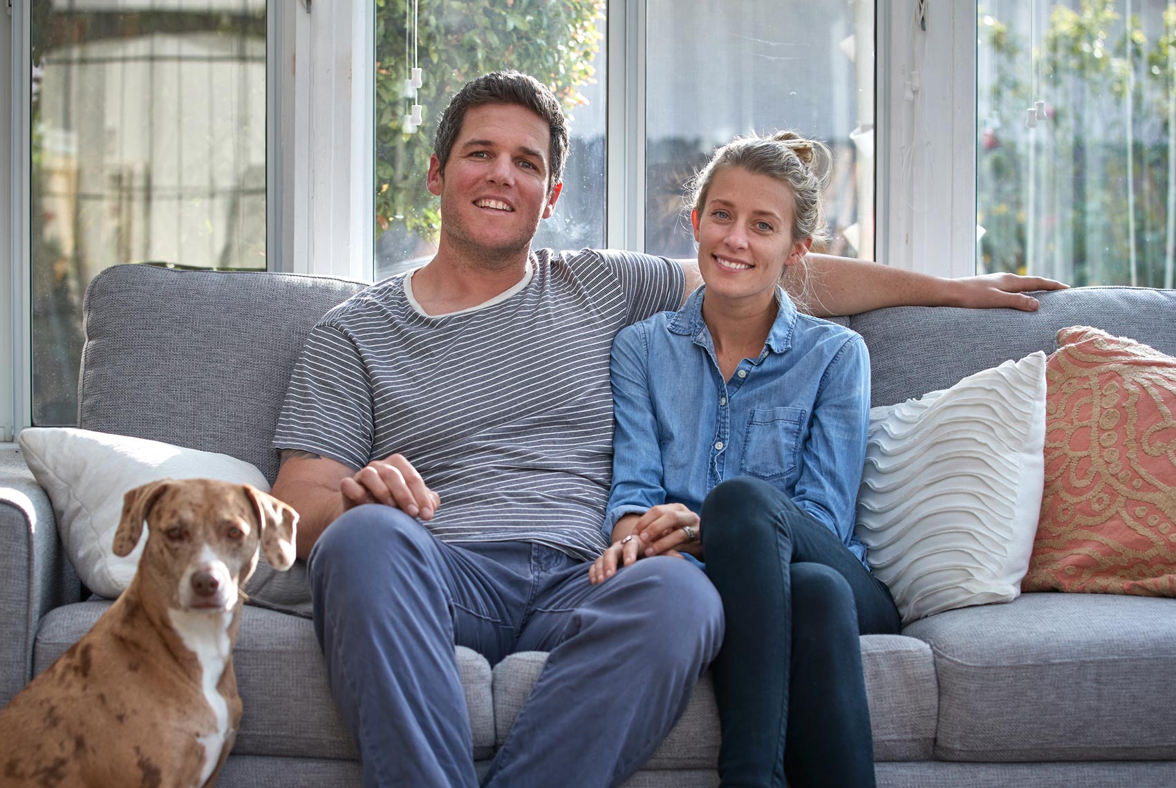 Foster Parent Couple on Couch with their Dog