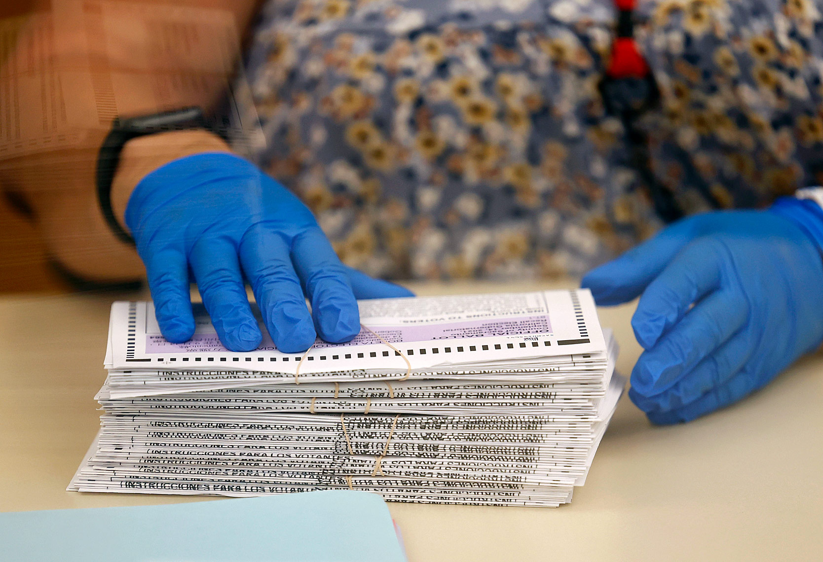 Worker With Stack of Ballots