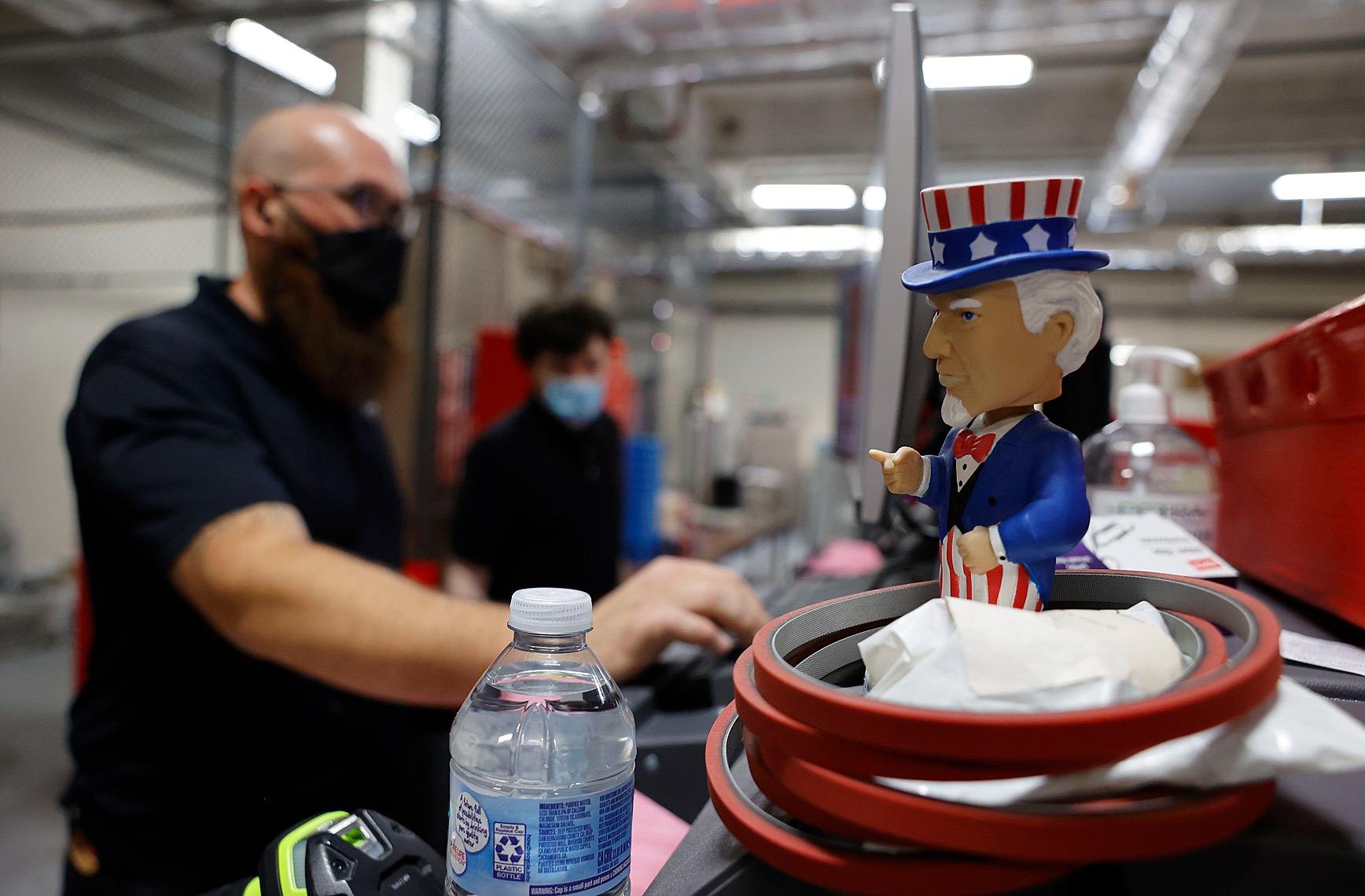 Uncle Sam bobblehead Watches Election Workers